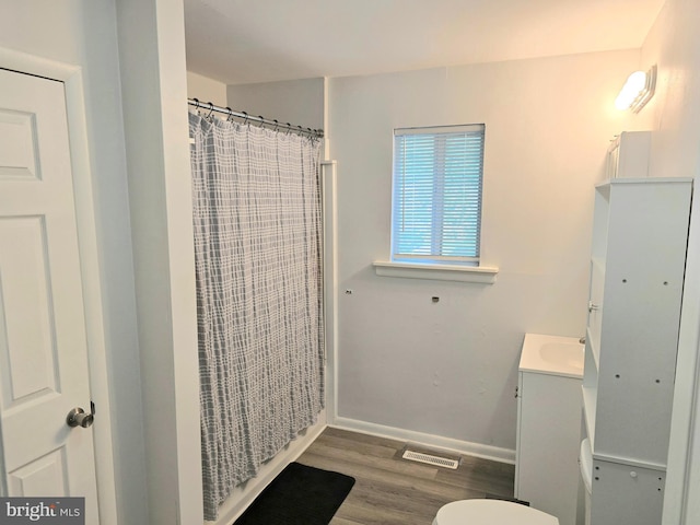 16 Egret Ct, Newark, DE 19702 - full bath featuring vanity, toilet, wood finished floors, and a shower with curtain