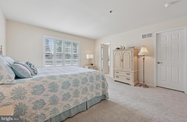 bedroom featuring light colored carpet, baseboards, and visible vents