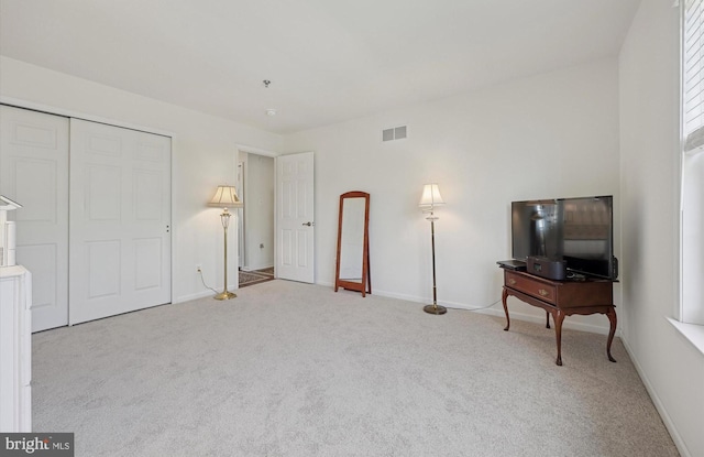 interior space featuring baseboards, visible vents, and carpet