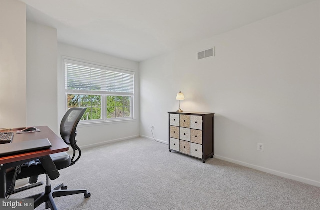 carpeted home office with baseboards and visible vents