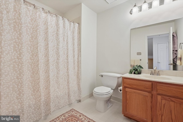 bathroom featuring vanity, tile patterned floors, and toilet