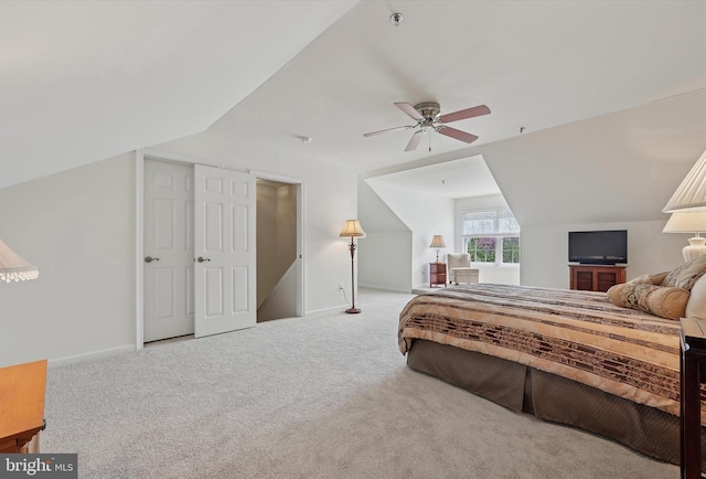 carpeted bedroom featuring baseboards, a ceiling fan, and lofted ceiling