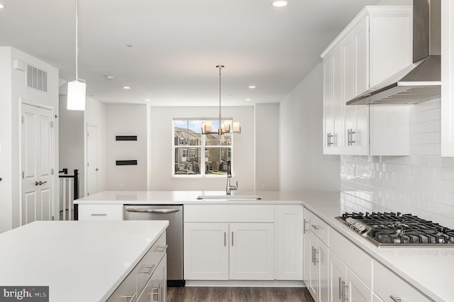 7241 Martin Farm Cir, Baltimore, MD 21237 - kitchen featuring wall chimney range hood, appliances with stainless steel finishes, a sink, a peninsula, and dark wood-style floors