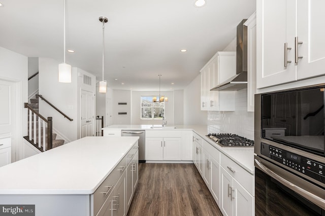 7241 Martin Farm Cir, Baltimore, MD 21237 - kitchen featuring wall chimney exhaust hood, stainless steel appliances, a sink, light countertops, and a peninsula