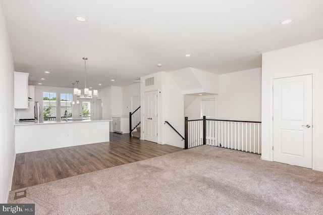 7241 Martin Farm Cir, Baltimore, MD 21237 - unfurnished living room featuring dark colored carpet, recessed lighting, a sink, and a chandelier