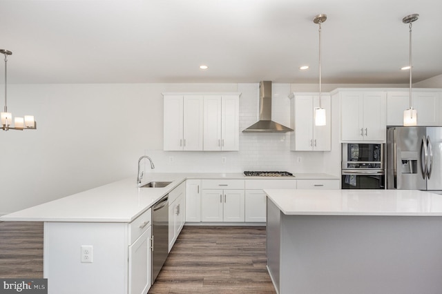 7241 Martin Farm Cir, Baltimore, MD 21237 - kitchen featuring wall chimney range hood, appliances with stainless steel finishes, a sink, dark wood finished floors, and light countertops