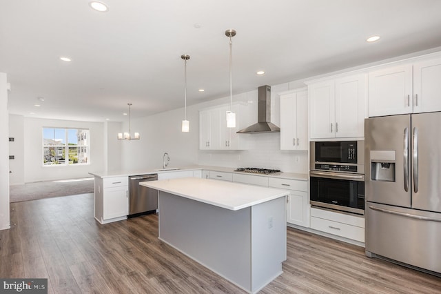 7241 Martin Farm Cir, Baltimore, MD 21237 - kitchen featuring stainless steel appliances, wall chimney exhaust hood, a sink, wood finished floors, and light countertops
