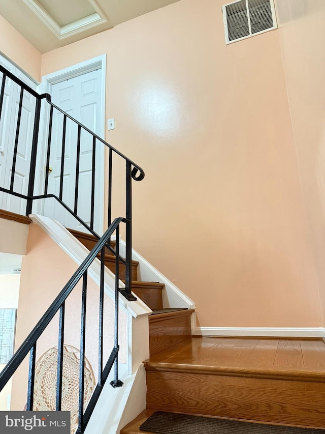 staircase featuring visible vents