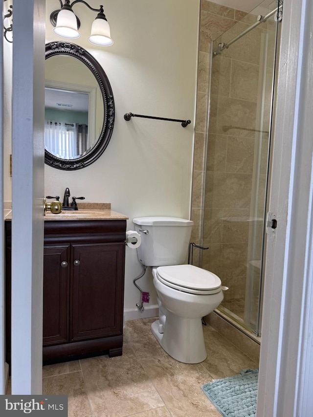 full bath featuring vanity, tile patterned flooring, toilet, baseboards, and a stall shower