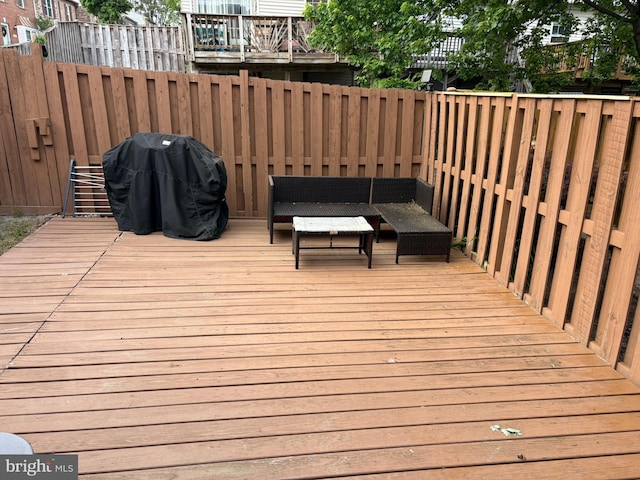 deck with an outdoor hangout area and area for grilling