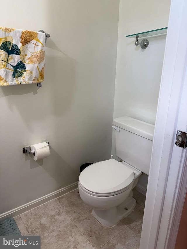 bathroom featuring toilet and baseboards