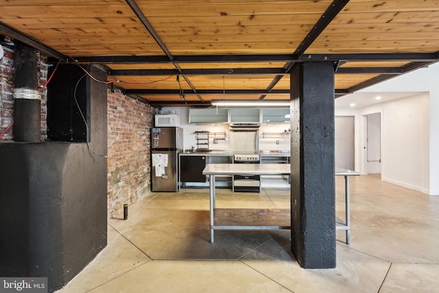 below grade area featuring freestanding refrigerator