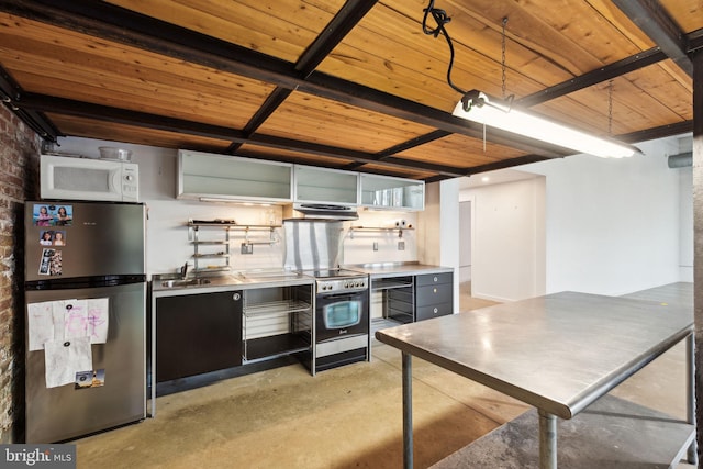 interior space with stainless steel countertops, wood ceiling, open shelves, stainless steel appliances, and concrete flooring