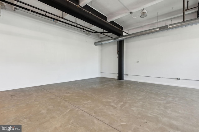 below grade area featuring baseboards and a garage