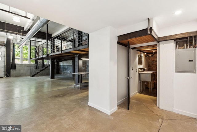 interior space featuring electric panel and baseboards