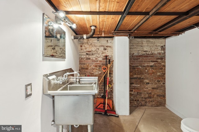 interior space with brick wall and concrete floors
