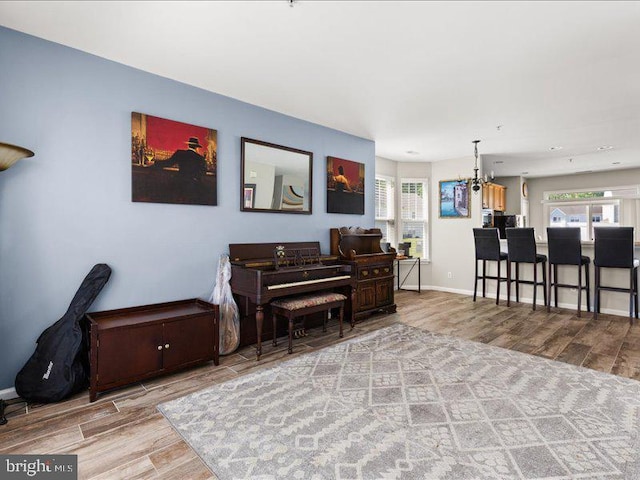 314 Schooner Ln, Berlin, MD 21811 - living room featuring wood finished floors, plenty of natural light, baseboards, and a chandelier