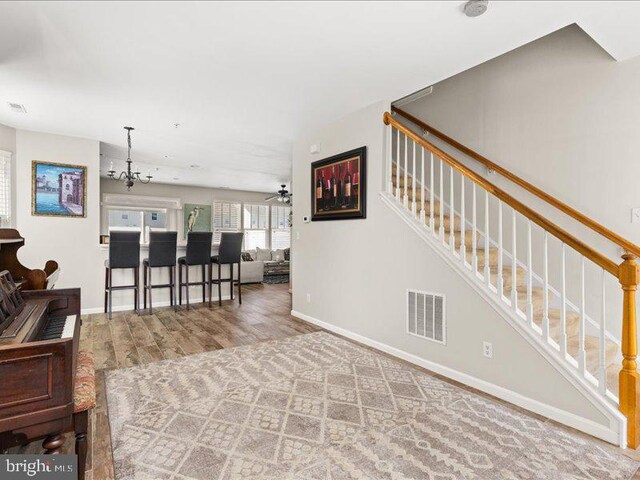 314 Schooner Ln, Berlin, MD 21811 - living area with wood finished floors, baseboards, and stairway