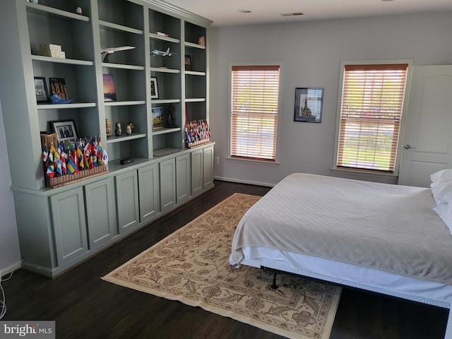 bedroom featuring baseboards, multiple windows, dark wood-type flooring, and visible vents
