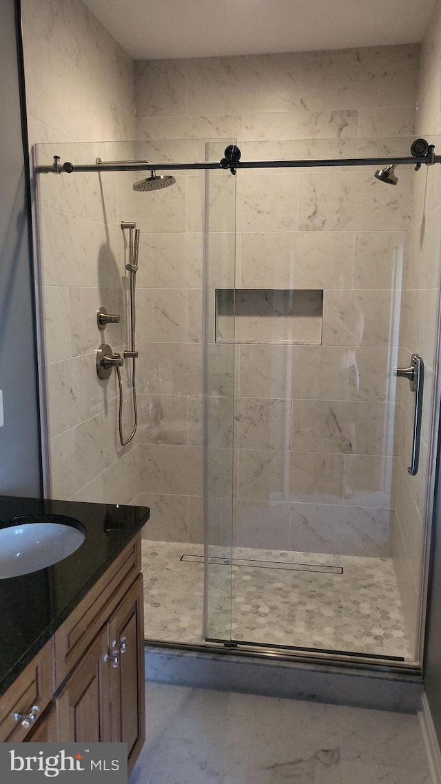 bathroom featuring a shower stall, marble finish floor, and vanity