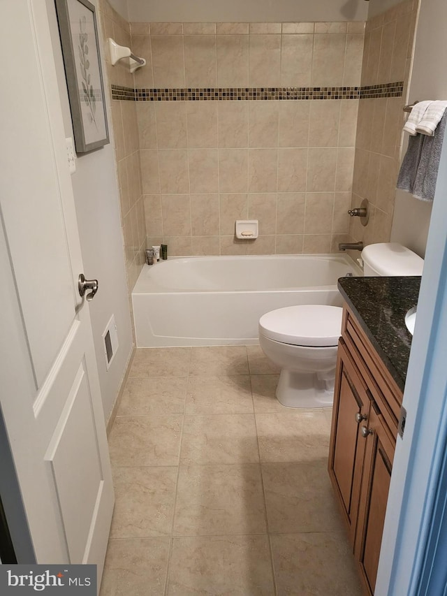 full bath with tile patterned flooring, bathtub / shower combination, toilet, and vanity