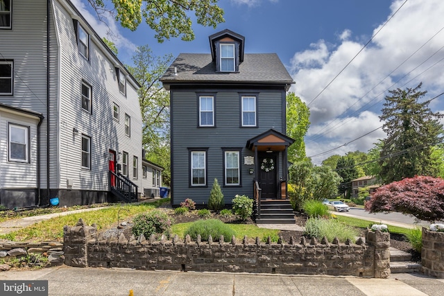 townhome / multi-family property with a shingled roof