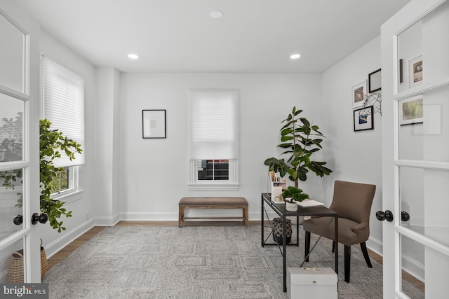 office with wood finished floors, healthy amount of natural light, french doors, recessed lighting, and baseboards