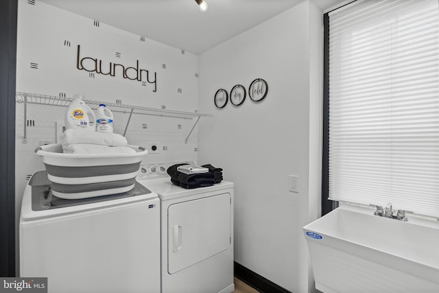 clothes washing area featuring independent washer and dryer