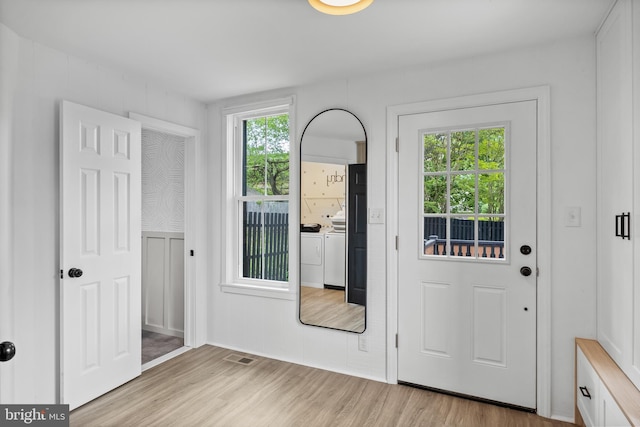 entryway featuring separate washer and dryer and light wood-style floors