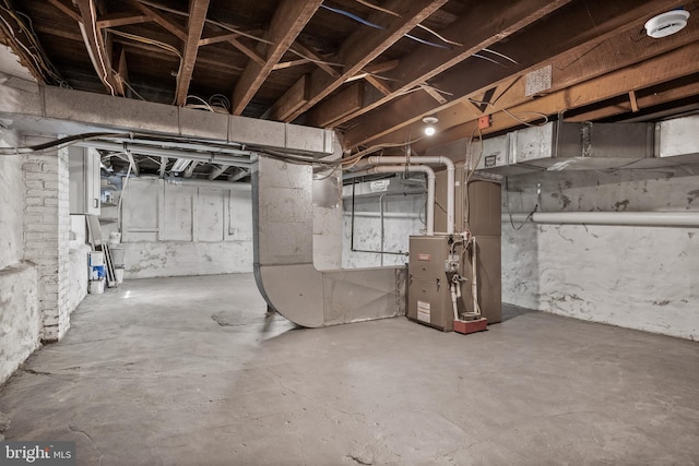 unfinished basement featuring heating unit