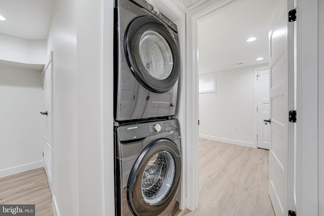 1621 Lyman Pl NE, Washington, DC 20002 - washroom with stacked washer / dryer, light wood-type flooring, baseboards, and recessed lighting