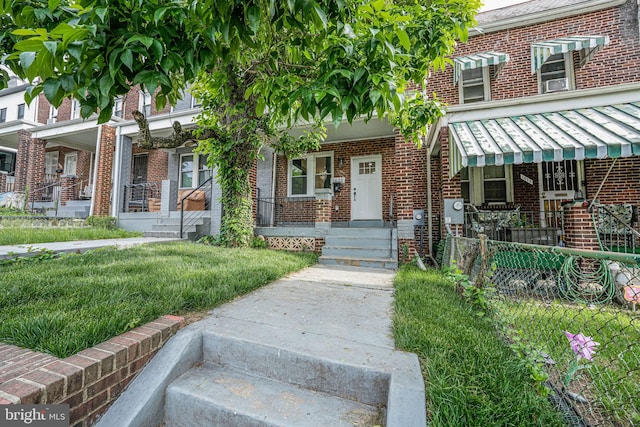 1621 Lyman Pl NE, Washington, DC 20002 - property entrance featuring brick siding, covered porch, and fence