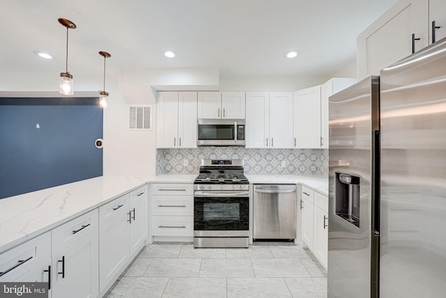 1621 Lyman Pl NE, Washington, DC 20002 - kitchen featuring stainless steel appliances, white cabinetry, tasteful backsplash, light stone countertops, and recessed lighting