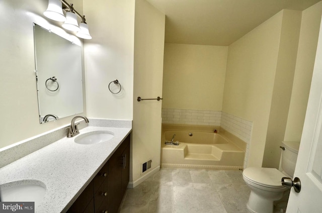 bathroom with a garden tub, double vanity, toilet, baseboards, and a sink