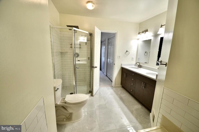 bathroom with tile patterned flooring, double vanity, toilet, a shower stall, and a sink