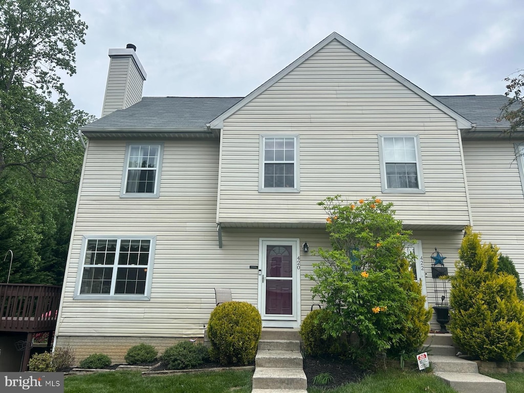 view of front facade with a chimney and a deck