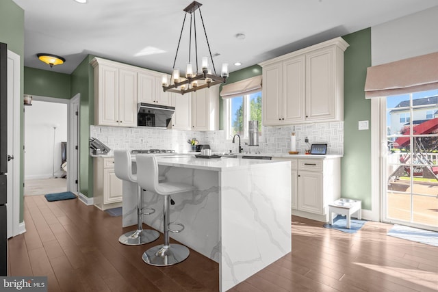 323 Palton Rd, Bensalem, PA 19020 - kitchen with dark wood-style flooring, decorative backsplash, light stone countertops, and recessed lighting
