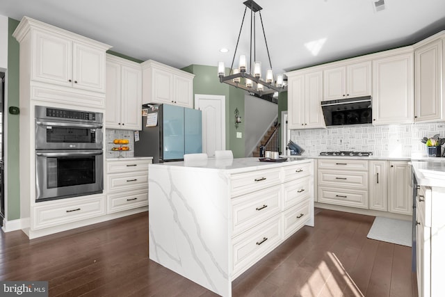323 Palton Rd, Bensalem, PA 19020 - kitchen with stainless steel appliances, dark wood finished floors, a center island, backsplash, and recessed lighting