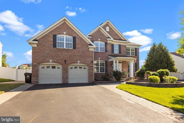 323 Palton Rd, Bensalem, PA 19020 - colonial house featuring asphalt driveway, brick siding, and a garage