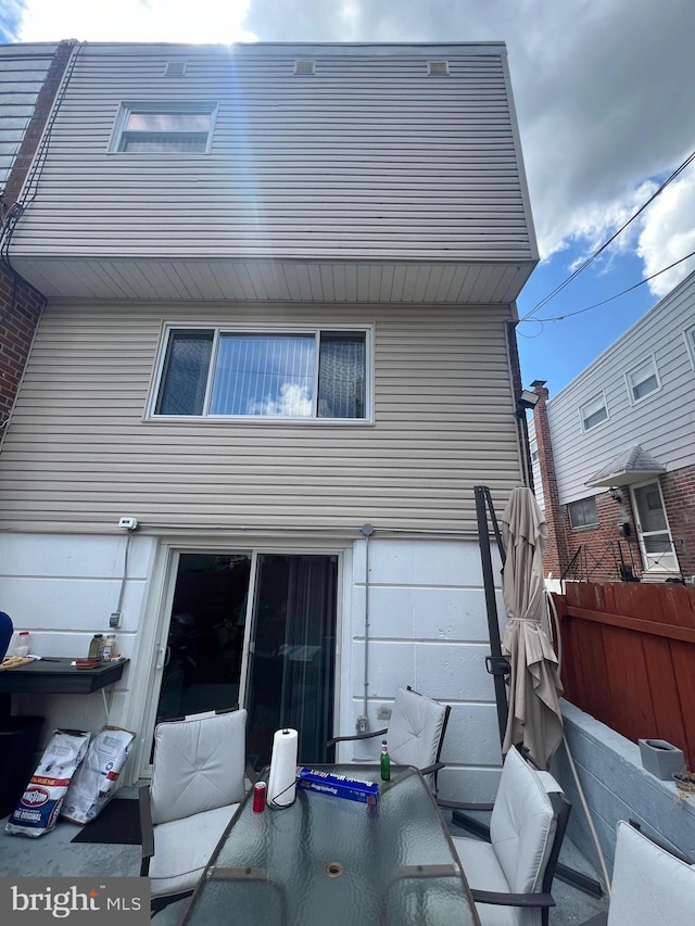 back of house featuring fence