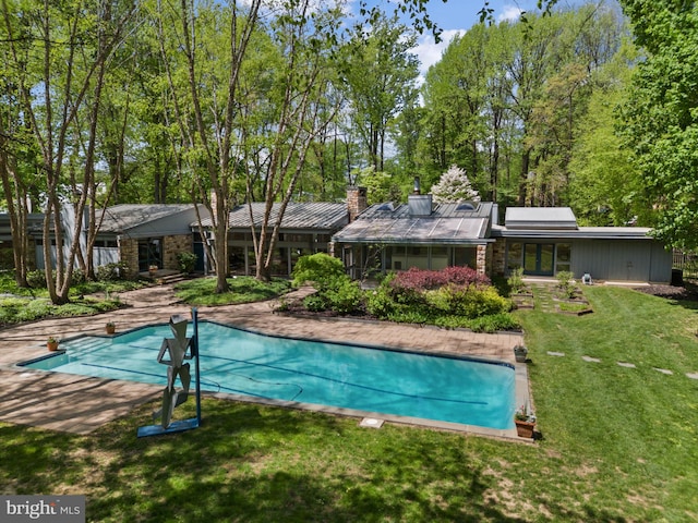 outdoor pool with a yard
