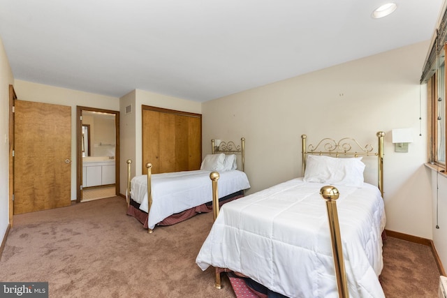 bedroom with carpet floors, baseboards, a closet, and connected bathroom