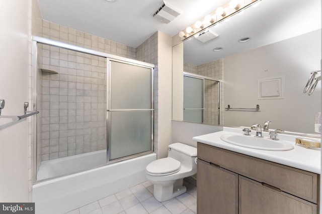 full bathroom featuring tile patterned floors, toilet, bath / shower combo with glass door, and vanity