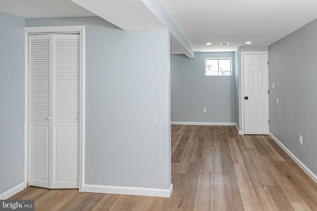 below grade area with baseboards and light wood-style flooring