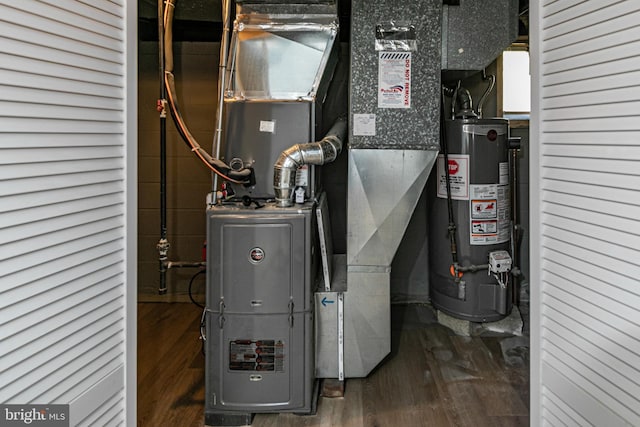 utility room featuring heating unit and gas water heater