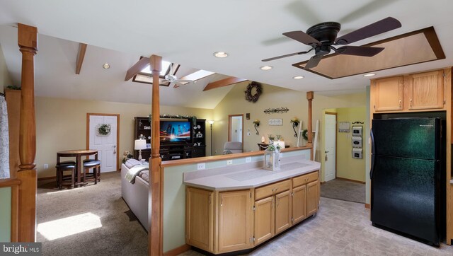 kitchen featuring freestanding refrigerator, a ceiling fan, vaulted ceiling, light countertops, and recessed lighting