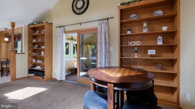 carpeted dining space with baseboards