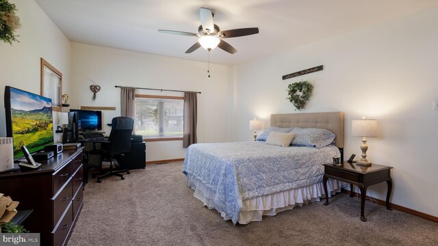 bedroom featuring an office area, carpet flooring, baseboards, and ceiling fan