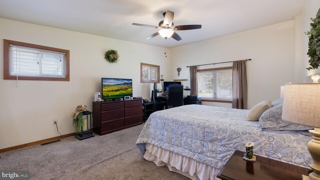 bedroom featuring carpet, a ceiling fan, baseboards, and an office area