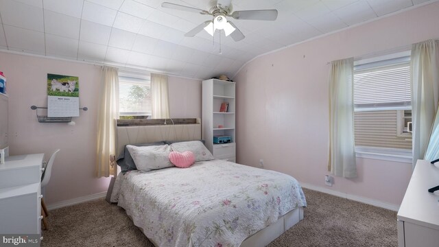 carpeted bedroom with vaulted ceiling, ceiling fan, and baseboards